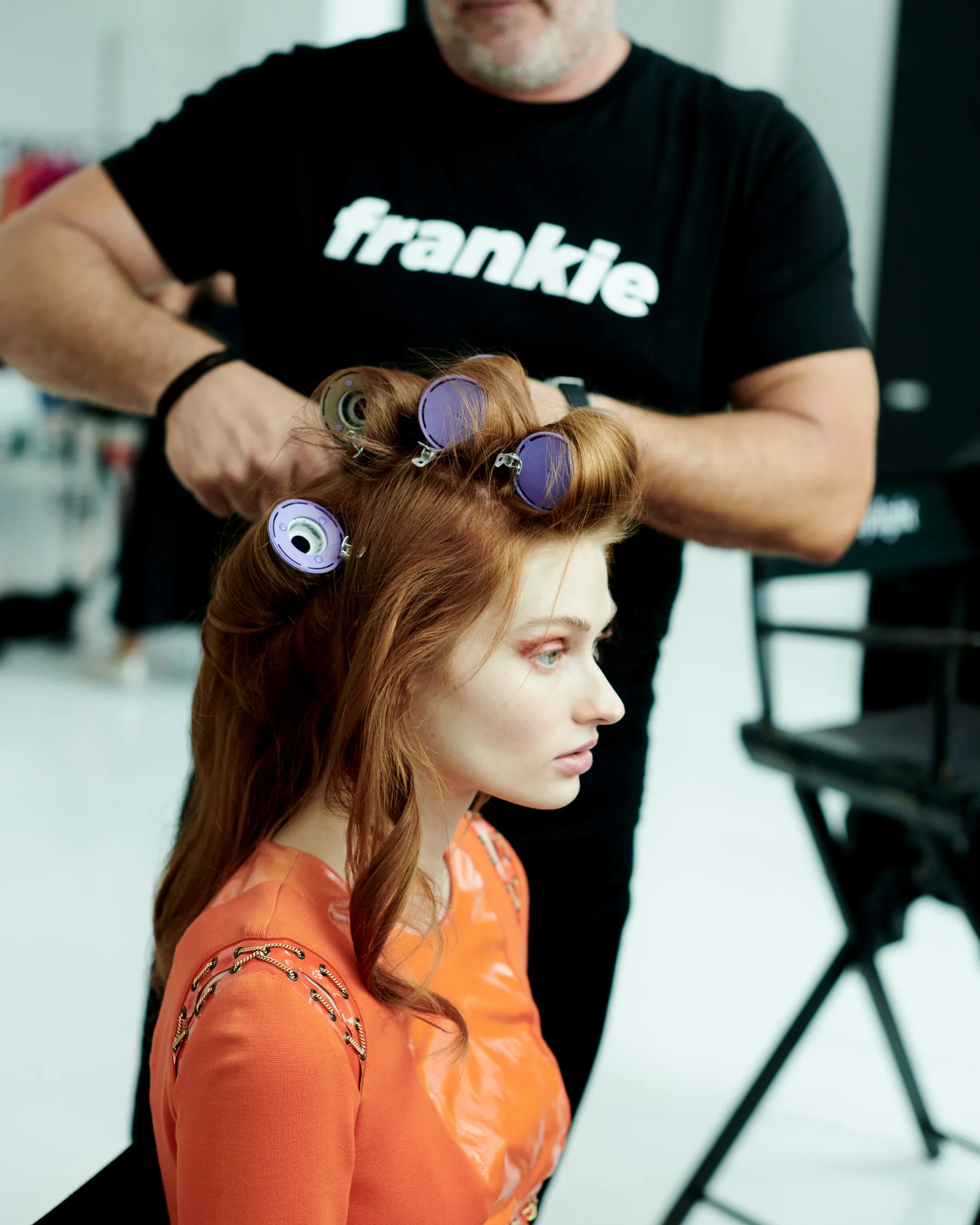 Frank Rizzieri setting rollers in a model’s hair